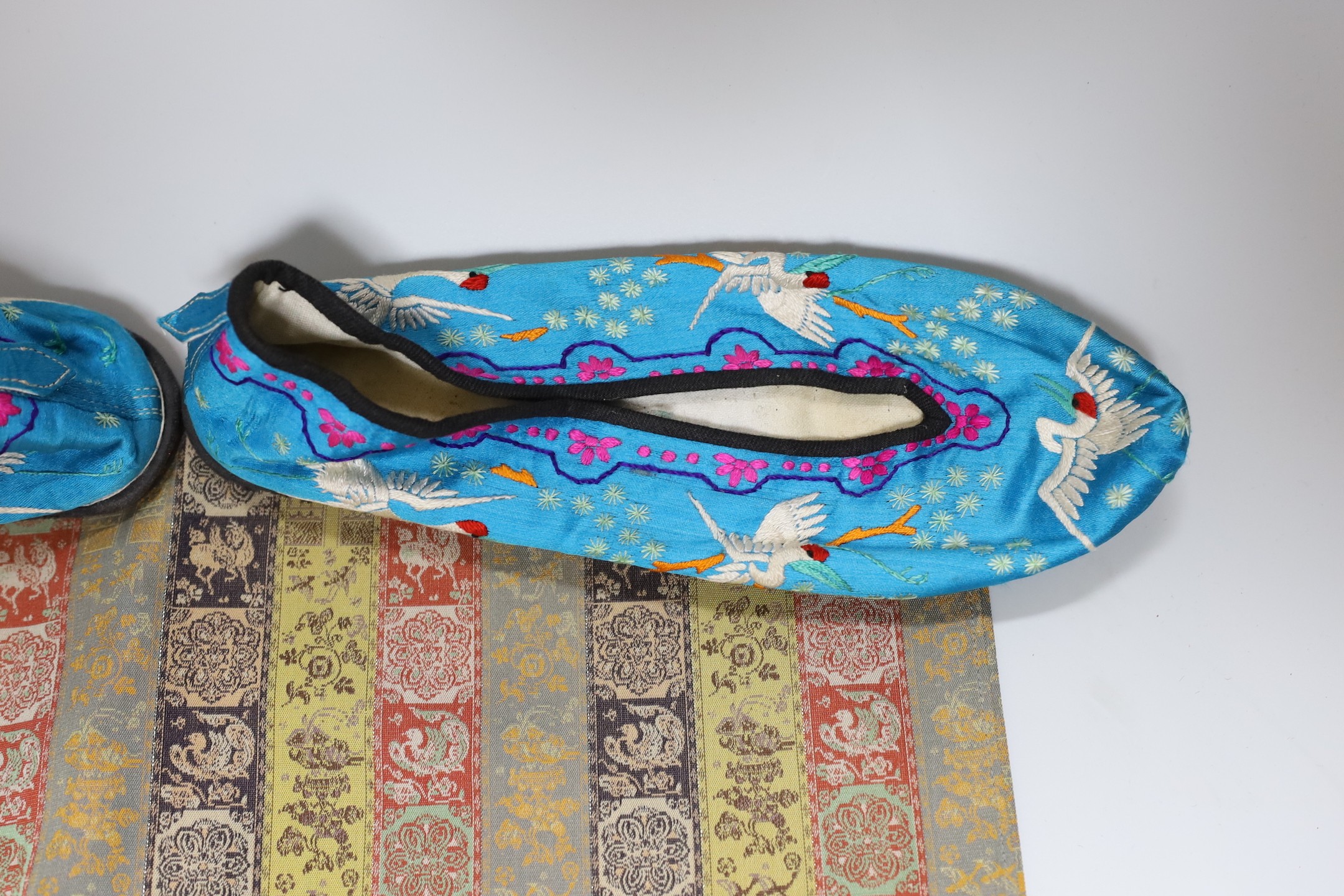 A pair of Chinese silkwork slippers and a Japanese table runner